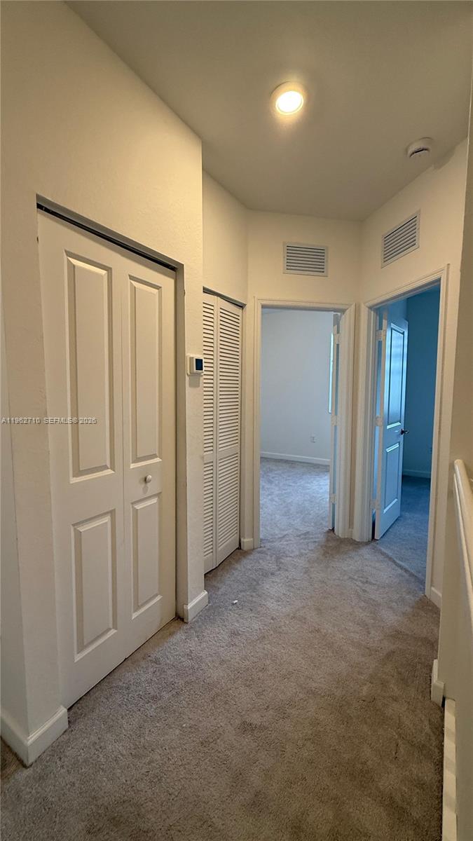 16244 Southwest 291st Street, Unit 16244 Homestead, FL 33033 - Photo 38 of 49 an empty room with closet and mirror