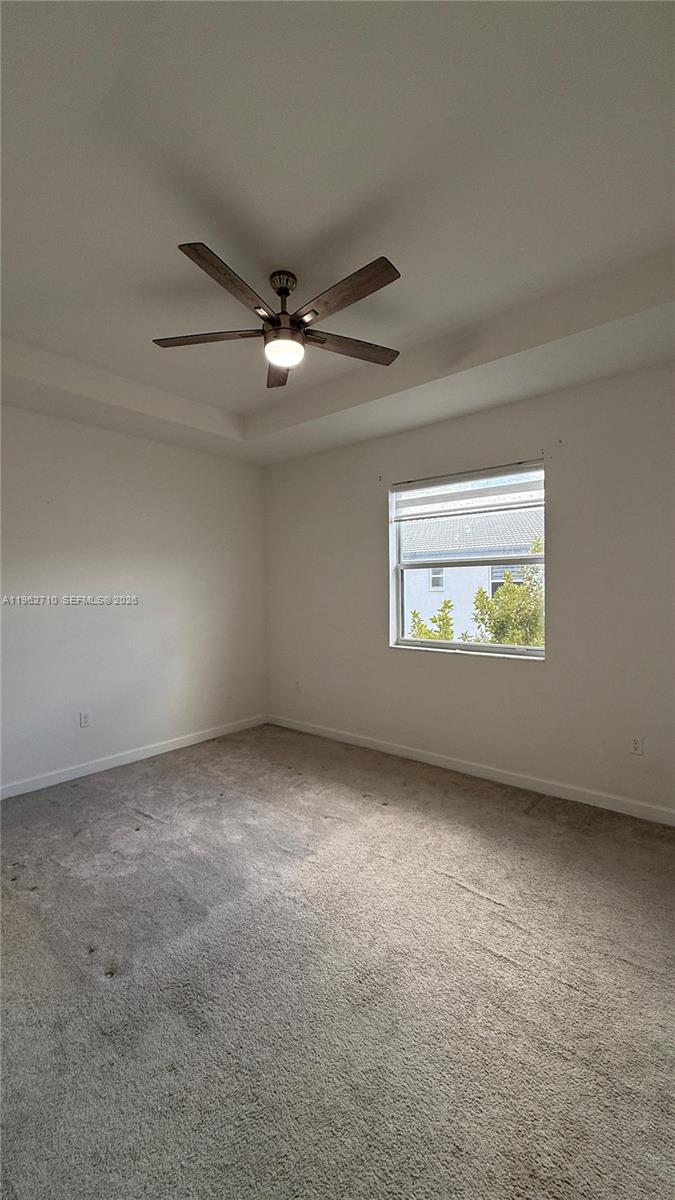 16244 Southwest 291st Street, Unit 16244 Homestead, FL 33033 - Photo 39 of 49 an empty room with windows and ceiling fan