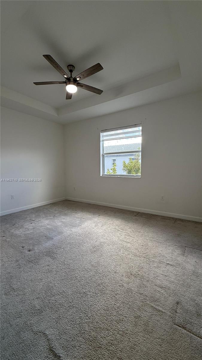 16244 Southwest 291st Street, Unit 16244 Homestead, FL 33033 - Photo 40 of 49 an empty room with a window and a ceiling fan