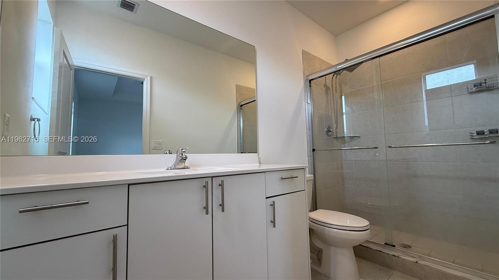 16244 Southwest 291st Street, Unit 16244 Homestead, FL 33033 - Photo 46 of 49 a bathroom with a sink toilet and shower