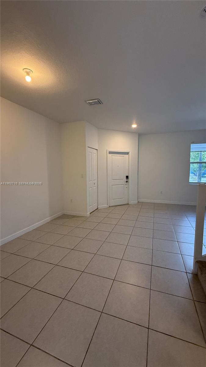 16244 Southwest 291st Street, Unit 16244 Homestead, FL 33033 - Photo 6 of 49 a view of an empty room and window