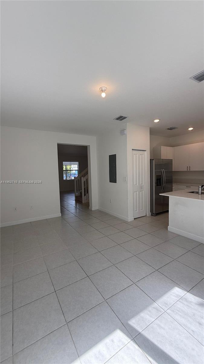 16244 Southwest 291st Street, Unit 16244 Homestead, FL 33033 - Photo 9 of 49 a view of a kitchen with a sink and a refrigerator