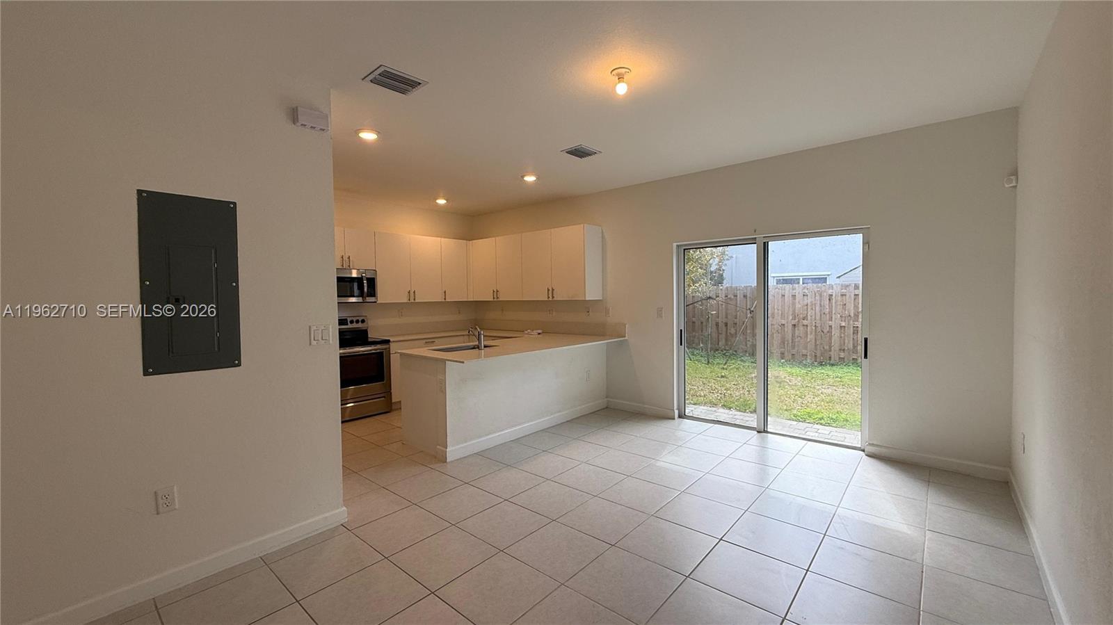 16244 Southwest 291st Street, Unit 16244 Homestead, FL 33033 - Photo 10 of 49 a large white kitchen with a sink and stainless steel appliances