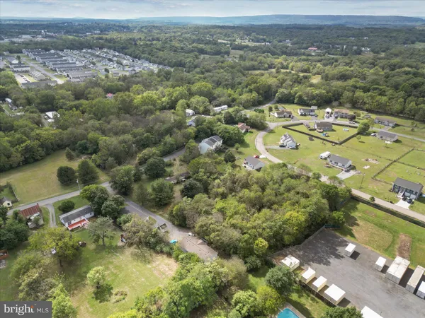 an aerial view of a houses with yard
