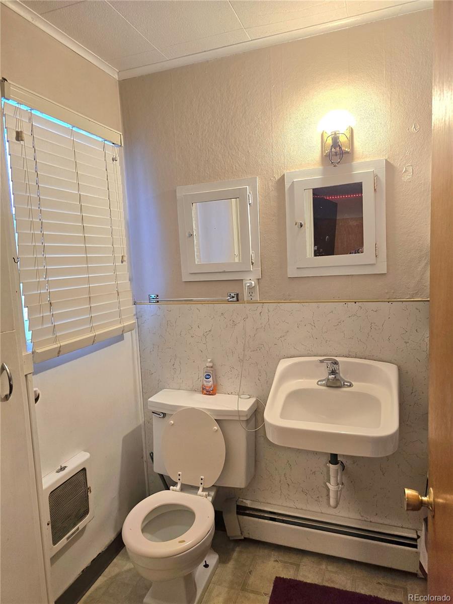 80 El Rio Drive, Unit 80 Alamosa, CO 81101 - Photo 8 of 12 a bathroom with a sink toilet and a mirror