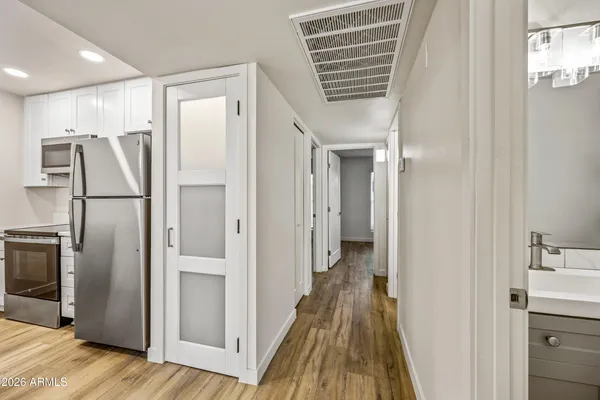 a view of a refrigerator in kitchen and wooden floor