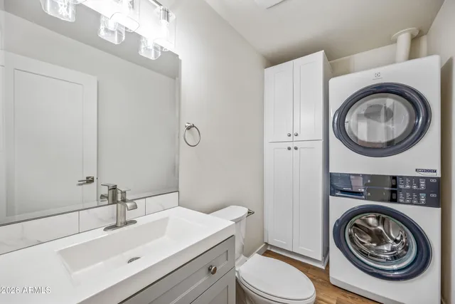 a bathroom with a sink a washer and dryer