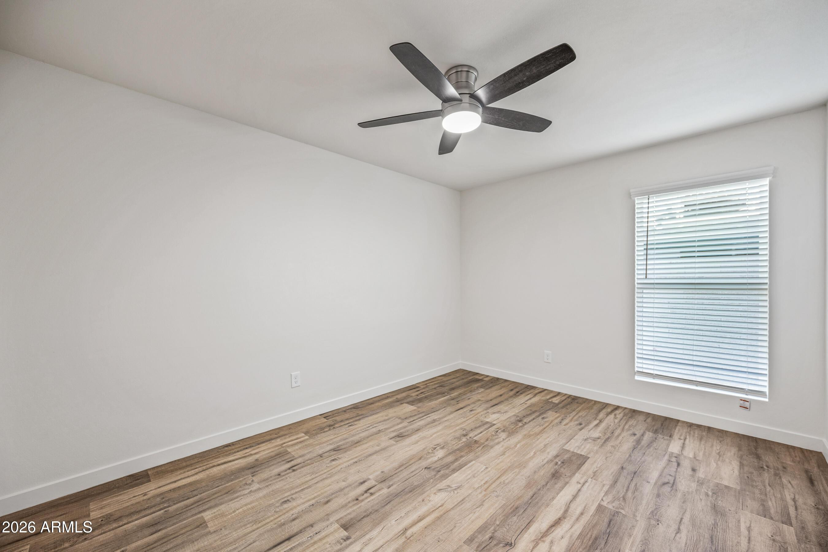 4139 North 27th Street, Unit 4 Phoenix, AZ 85016 - Photo 16 of 29 wooden floor in an empty room with a window