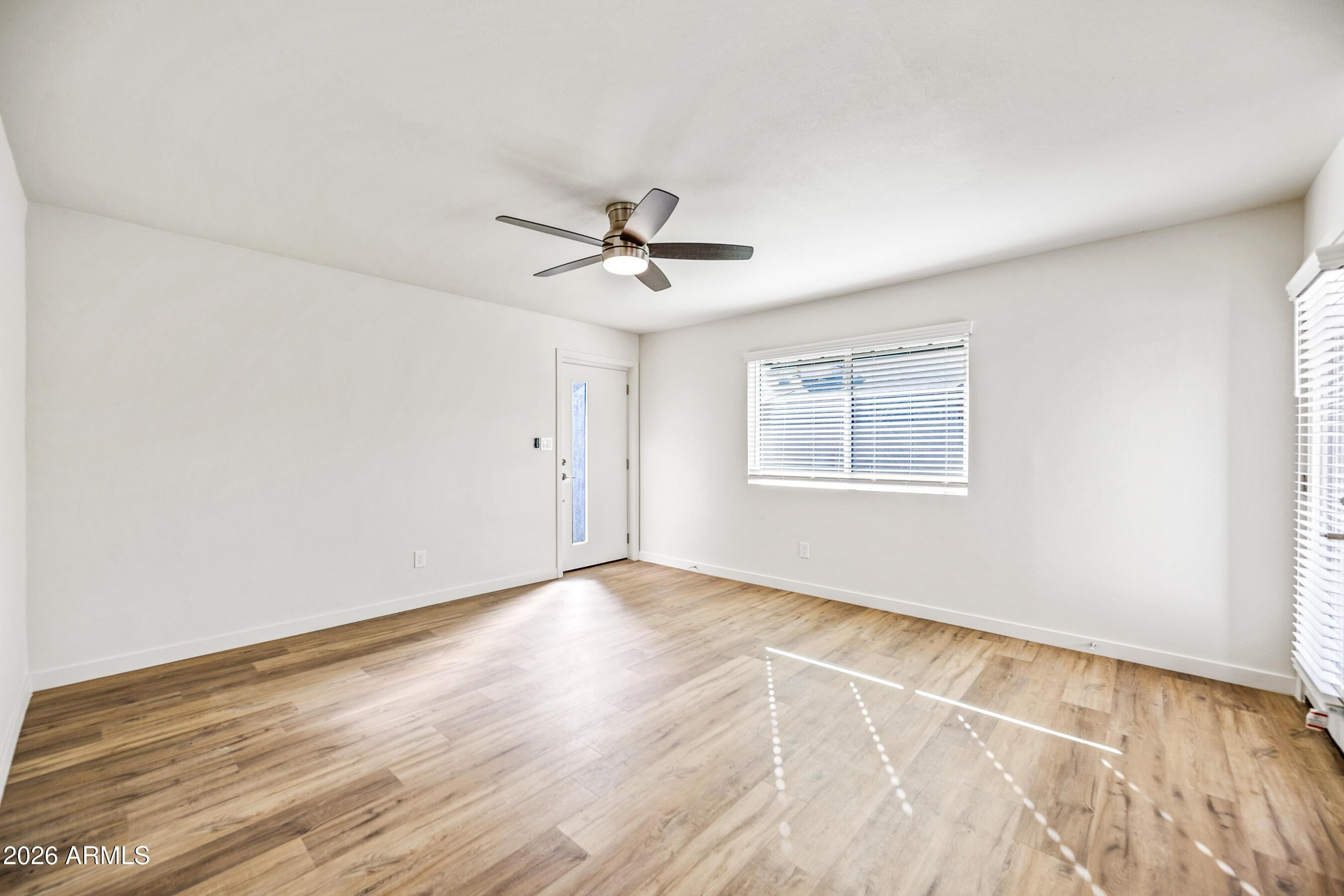 4139 North 27th Street, Unit 4 Phoenix, AZ 85016 - Photo 7 of 29 wooden floor in an empty room with a window