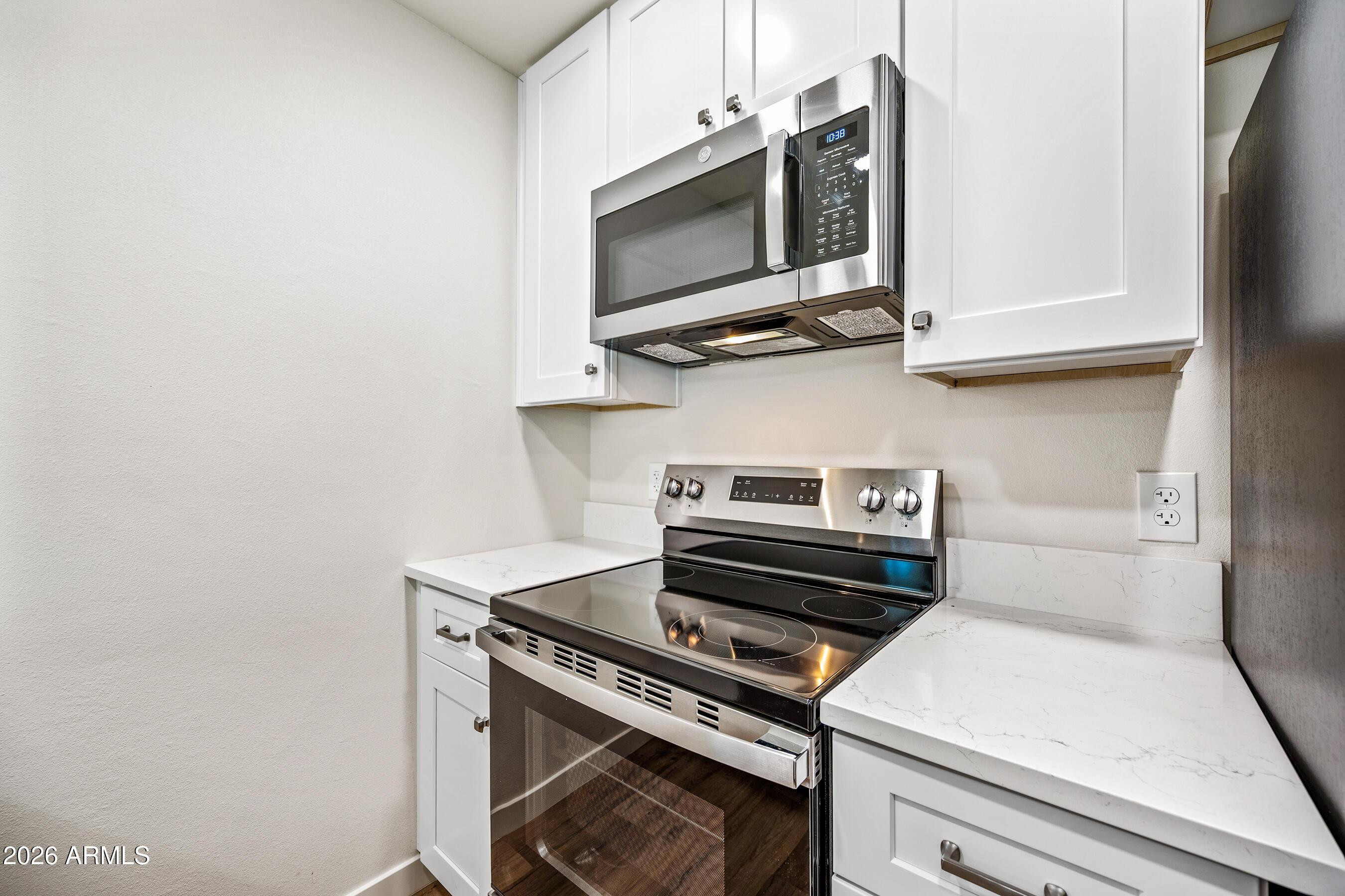 4139 North 27th Street, Unit 4 Phoenix, AZ 85016 - Photo 10 of 29 a kitchen with a stove and a microwave
