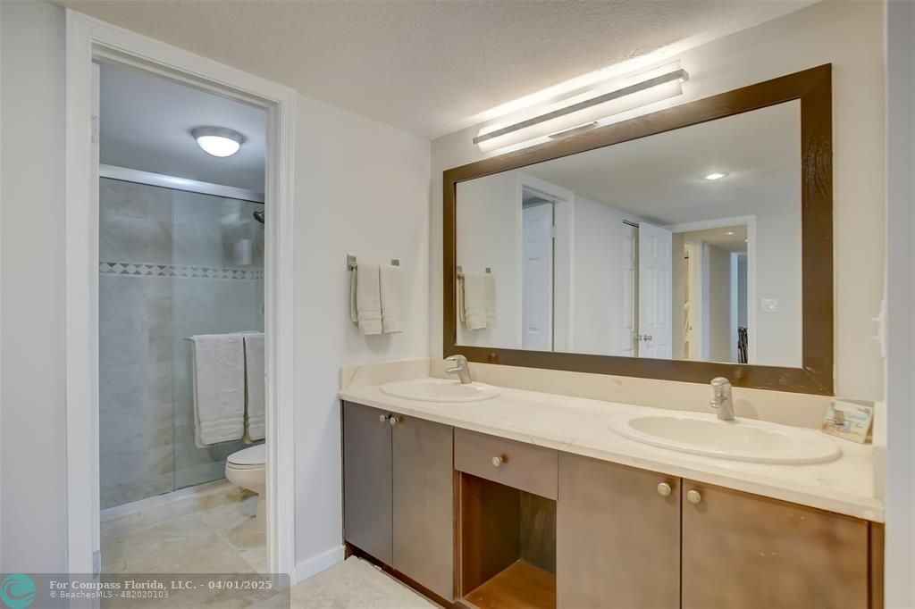 1000 South Ocean Boulevard, Unit 5O Pompano Beach, FL 33062 - Photo 20 of 42 a bathroom with a double vanity sink mirror and toilet