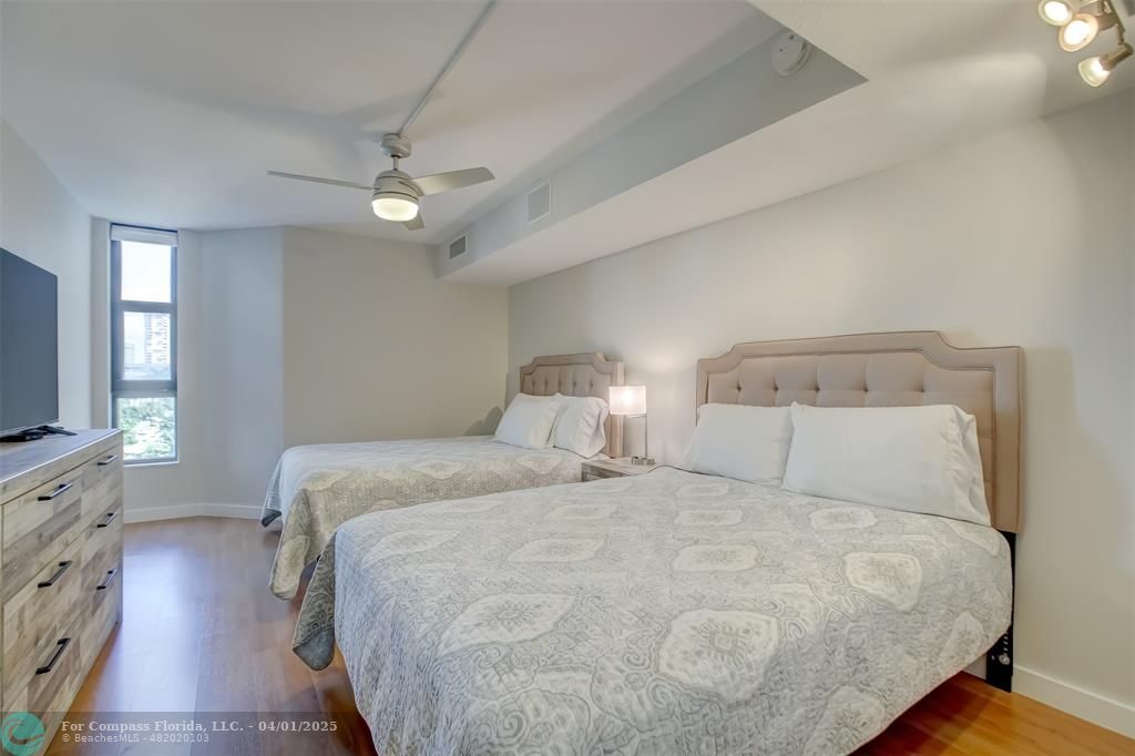 1000 South Ocean Boulevard, Unit 5O Pompano Beach, FL 33062 - Photo 23 of 42 a bedroom with a large bed and a flat tv screen on dresser