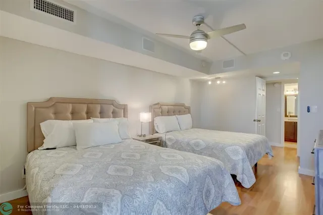 a bedroom with a bed and a lamp