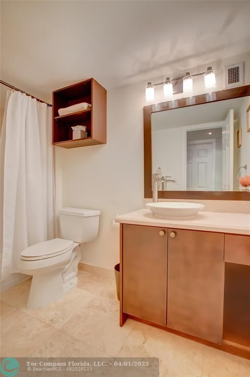 1000 South Ocean Boulevard, Unit 5O Pompano Beach, FL 33062 - Photo 26 of 42 a bathroom with a toilet a sink and mirror