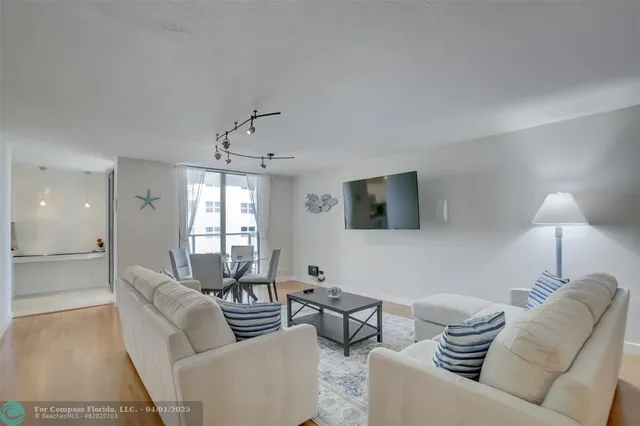 a living room with furniture and a lamp