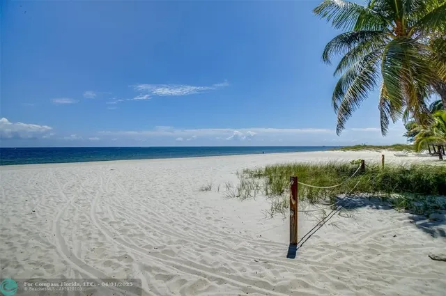 a view of a lake with a table and chairs