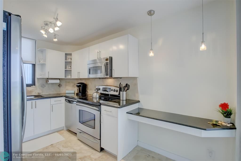 1000 South Ocean Boulevard, Unit 5O Pompano Beach, FL 33062 - Photo 7 of 42 a kitchen that has a lot of cabinets and appliances in it