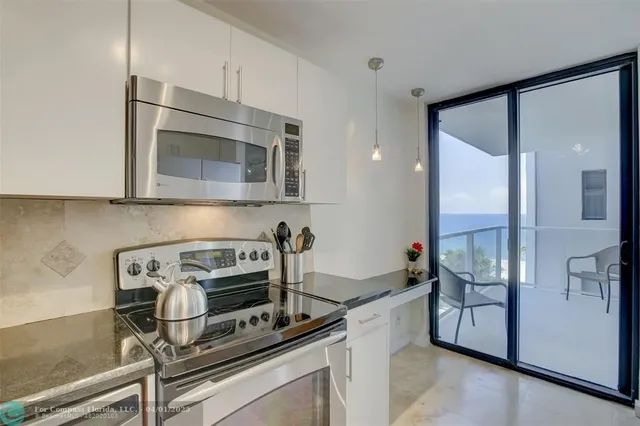 a kitchen with appliances a counter space and cabinets