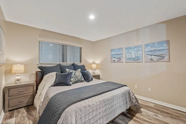 a bedroom with a bed and a night stand