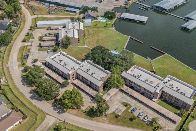 an aerial view of a residential houses with outdoor space