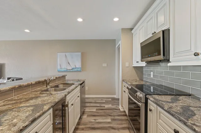 a kitchen that has a sink and a stove