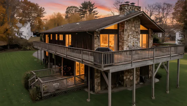 a view of house with swimming pool and porch