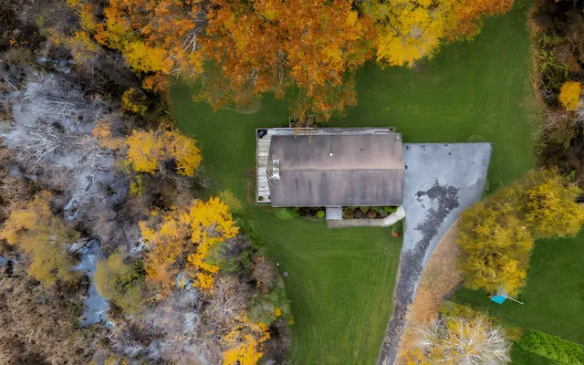 an aerial view of a house with a yard basket ball court and outdoor seating