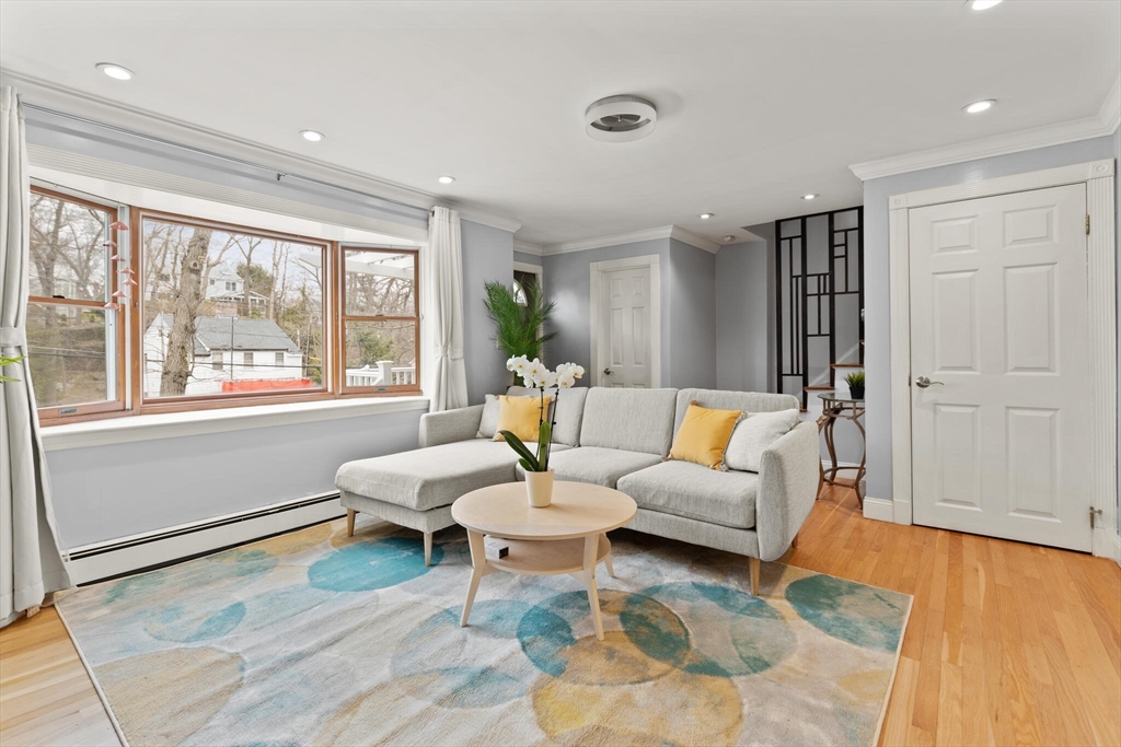50 Thurston Road, Unit 50 Newton, MA 02464 - Photo 1 of 26 a living room with furniture and wooden floor
