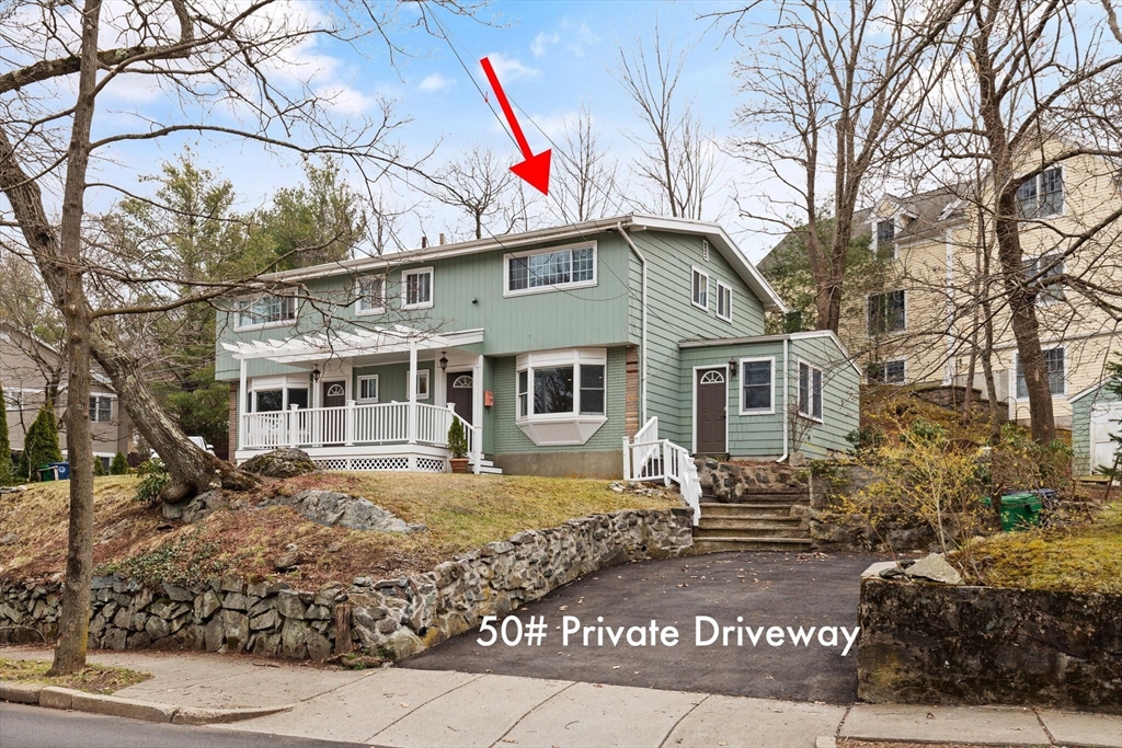 50 Thurston Road, Unit 50 Newton, MA 02464 - Photo 2 of 26 a front view of a house with a yard