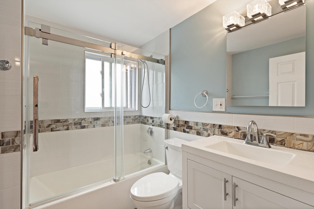 50 Thurston Road, Unit 50 Newton, MA 02464 - Photo 21 of 26 a bathroom with a sink mirror toilet and bathtub