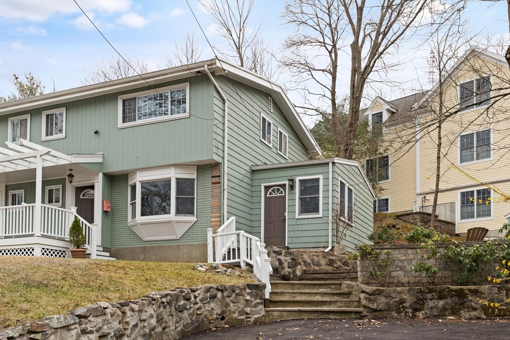 50 Thurston Road, Unit 50 Newton, MA 02464 - Photo 3 of 26 a front view of a house with a yard