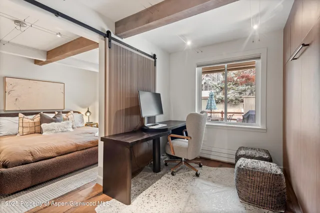 a bedroom with furniture and a window