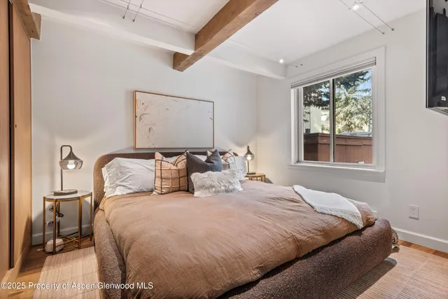 a bedroom with a large bed and a window