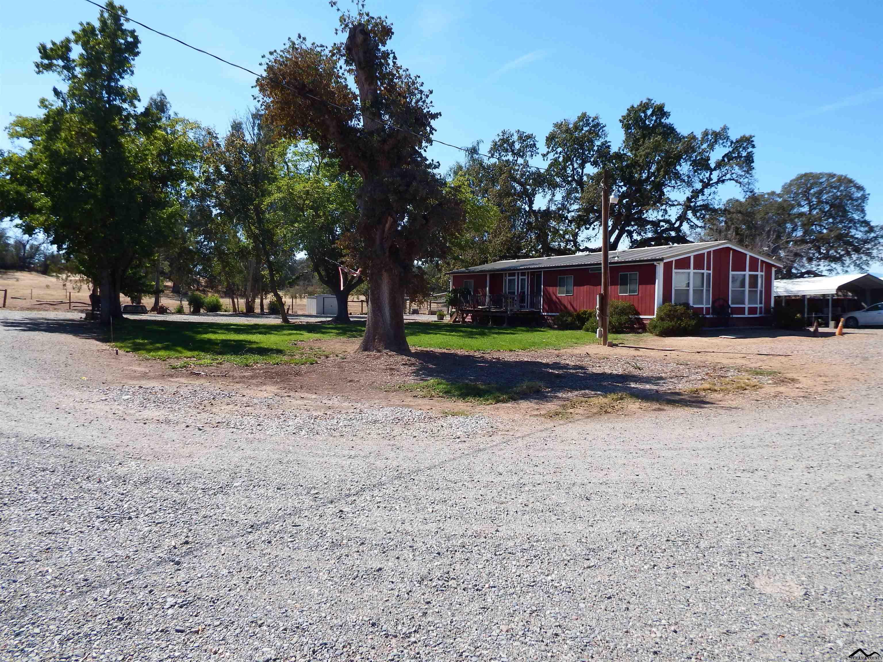 12535 Wilder Road Red Bluff, CA 96080 - Photo 2 of 30 a view of a house with a yard and a large tree