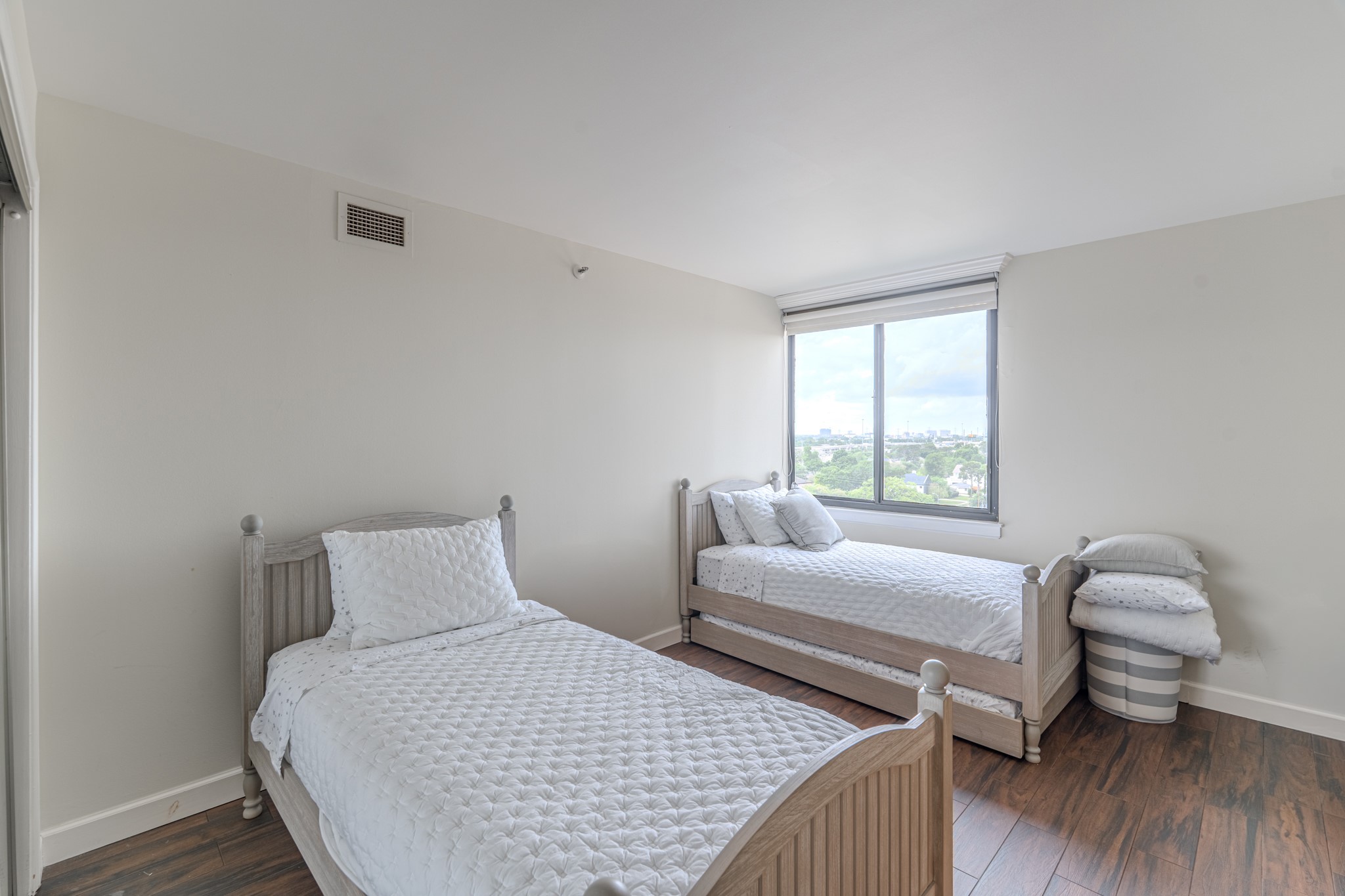 3525 Sage Road, Unit 1016 Houston, TX 77056 - Photo 38 of 42 a bedroom with a bed and wooden floor