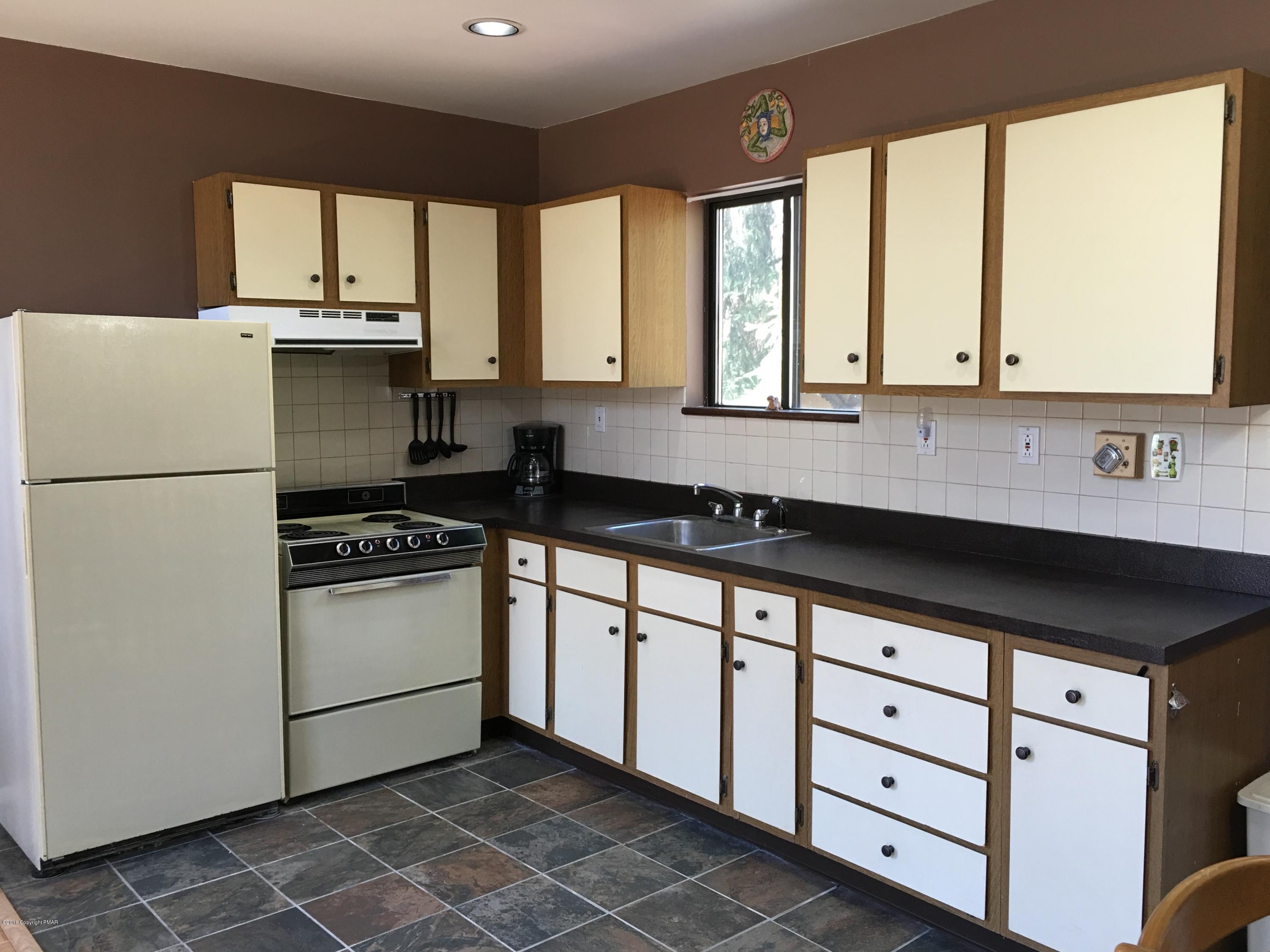 1034 Beaver Run Road Newfoundland, PA 18445 - Photo 6 of 23 a kitchen with a sink a stove and a refrigerator
