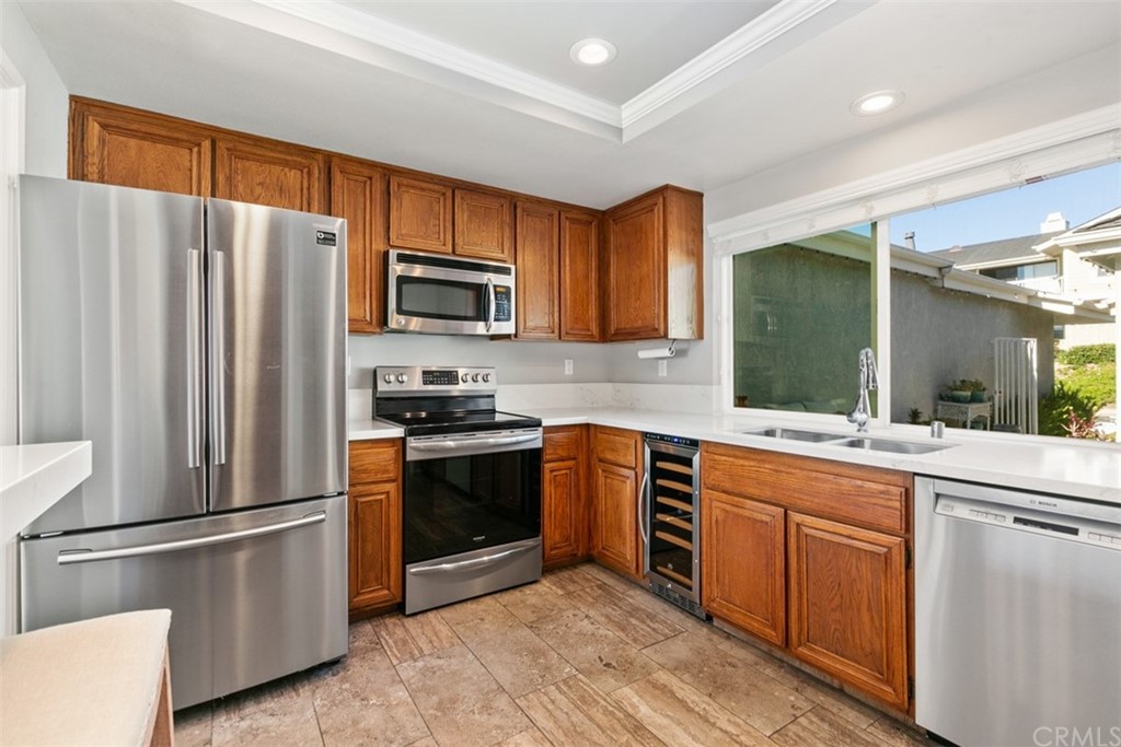 24746 Evening Star Drive, Unit 18 Dana Point, CA 92629 - Photo 14 of 42 a kitchen with stainless steel appliances granite countertop a refrigerator stove microwave and sink