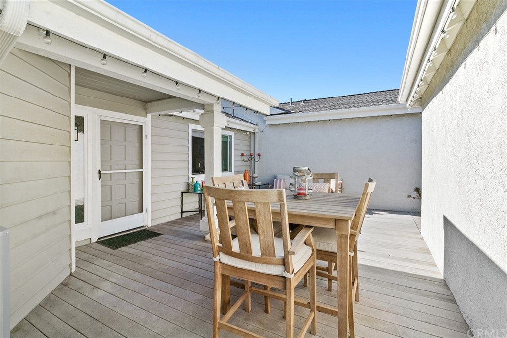 24746 Evening Star Drive, Unit 18 Dana Point, CA 92629 - Photo 15 of 42 a view of a dining room with furniture and wooden floor