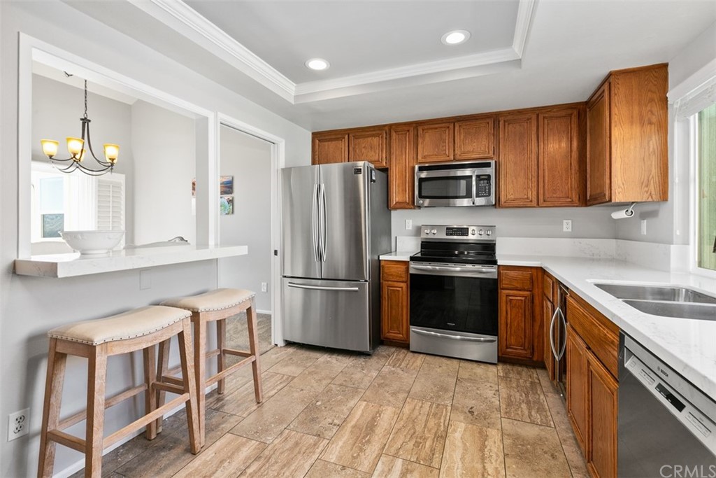 24746 Evening Star Drive, Unit 18 Dana Point, CA 92629 - Photo 16 of 42 a kitchen with a refrigerator stove and microwave
