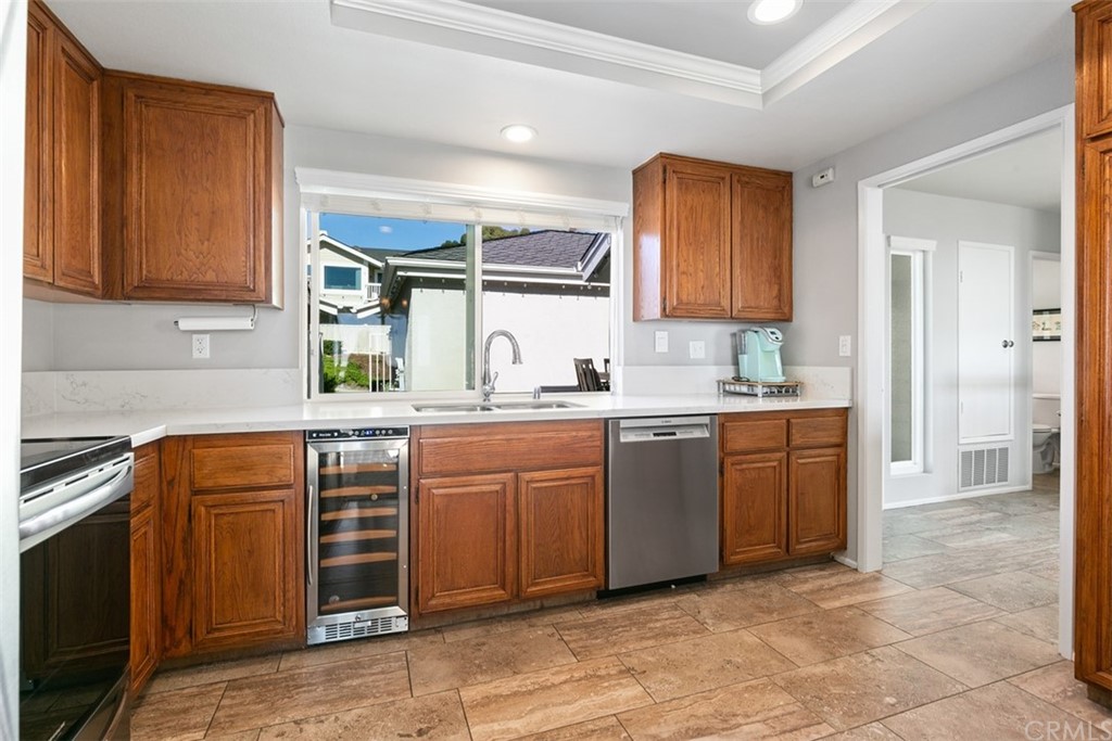 24746 Evening Star Drive, Unit 18 Dana Point, CA 92629 - Photo 17 of 42 a kitchen with granite countertop a sink cabinets and stainless steel appliances