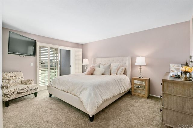 a bedroom with a bed and dresser with window