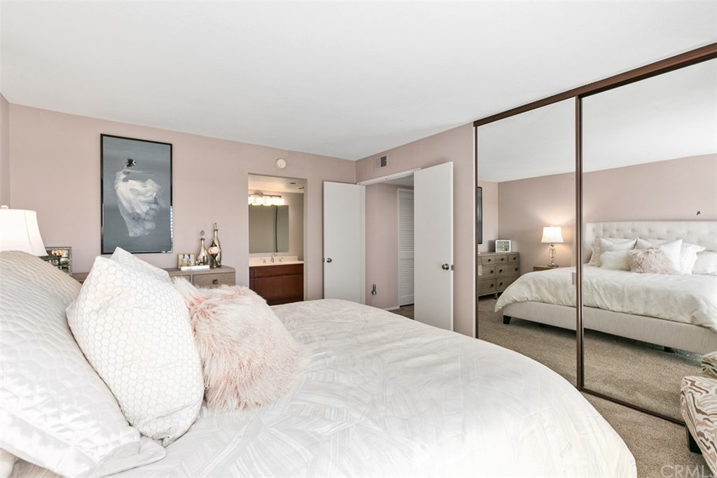 24746 Evening Star Drive, Unit 18 Dana Point, CA 92629 - Photo 20 of 42 a bedroom with a large bed and large mirror