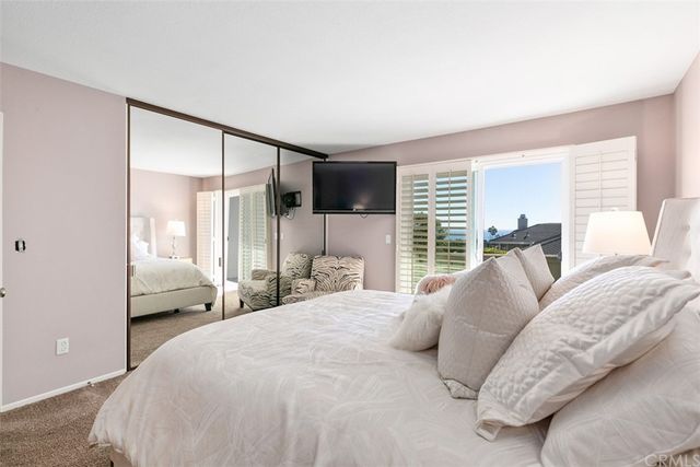 a bedroom with a large bed and a large window