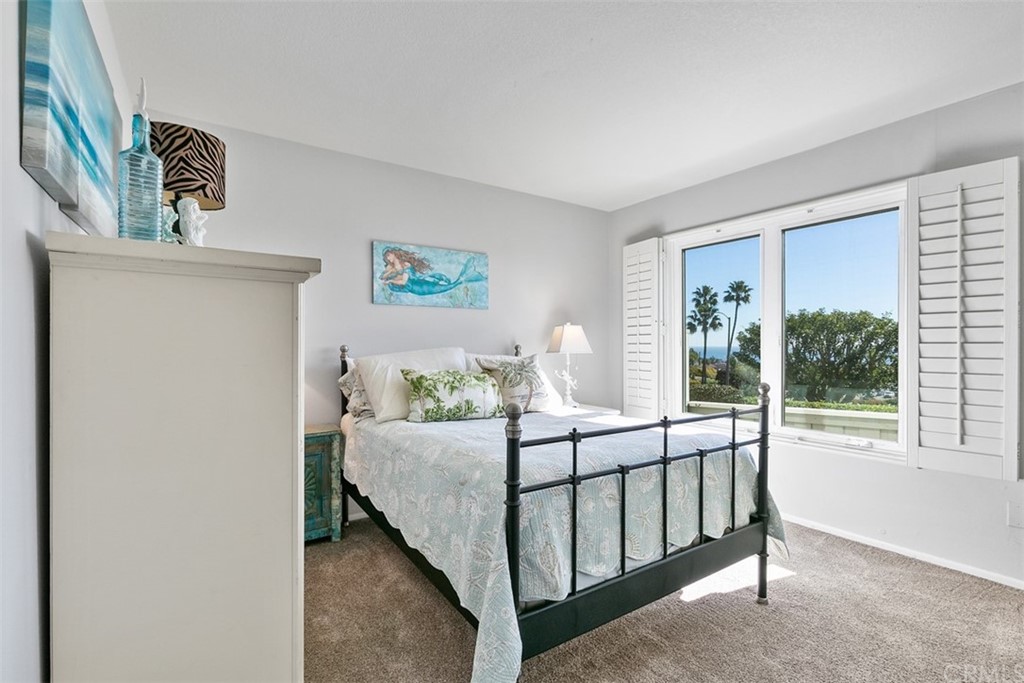 24746 Evening Star Drive, Unit 18 Dana Point, CA 92629 - Photo 23 of 42 a bedroom with a bed and a window