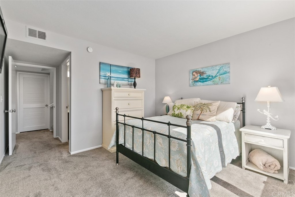 24746 Evening Star Drive, Unit 18 Dana Point, CA 92629 - Photo 24 of 42 a bedroom with furniture and a fireplace