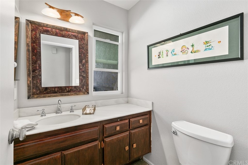 24746 Evening Star Drive, Unit 18 Dana Point, CA 92629 - Photo 26 of 42 a bathroom with a toilet sink and mirror