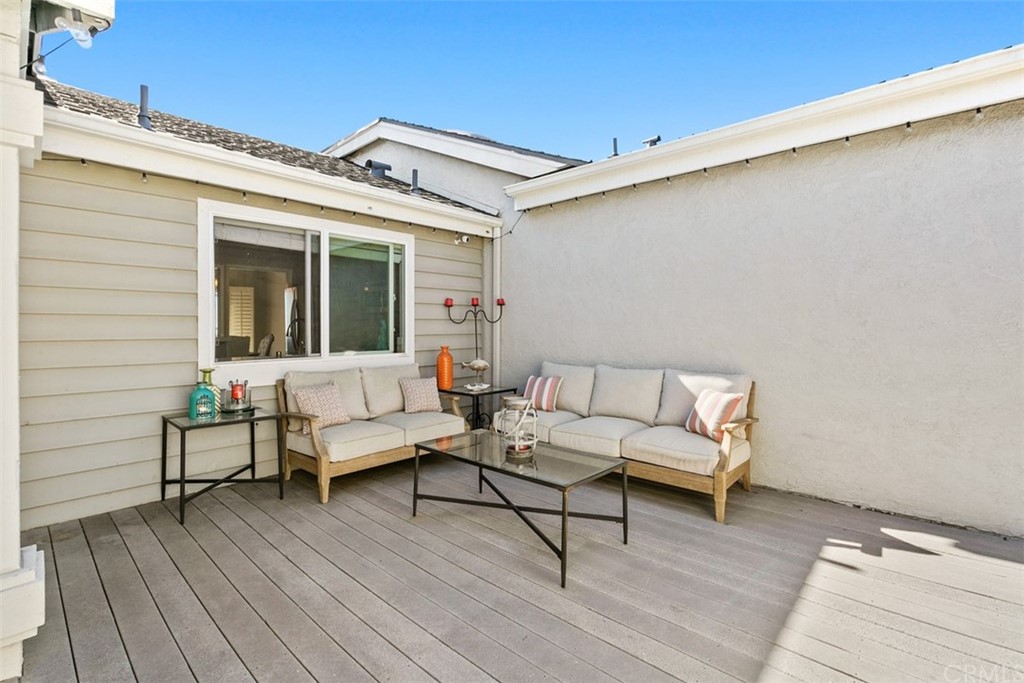 24746 Evening Star Drive, Unit 18 Dana Point, CA 92629 - Photo 33 of 42 a view of a patio with couches and table with wooden floor