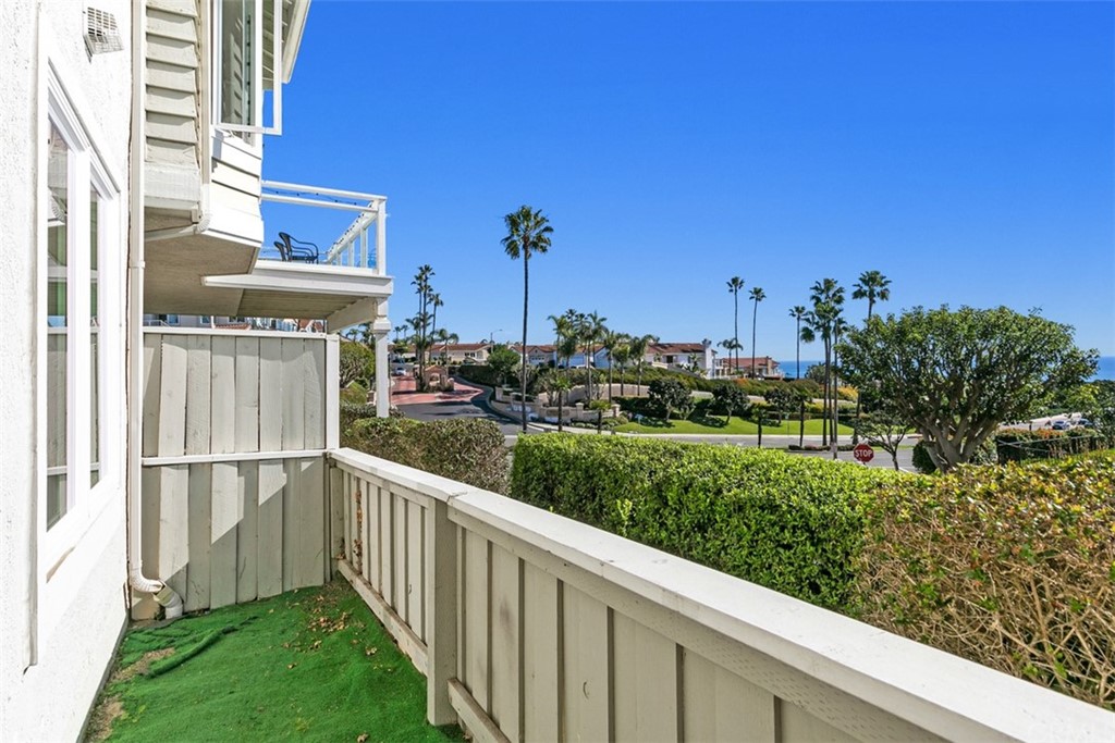 24746 Evening Star Drive, Unit 18 Dana Point, CA 92629 - Photo 34 of 42 a view of a garden with a building in the background