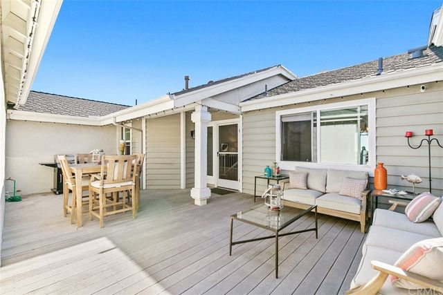 a outdoor space with patio the couches and a dining table with wooden floor