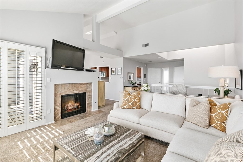 24746 Evening Star Drive, Unit 18 Dana Point, CA 92629 - Photo 6 of 42 a living room with furniture a flat screen tv and a fireplace